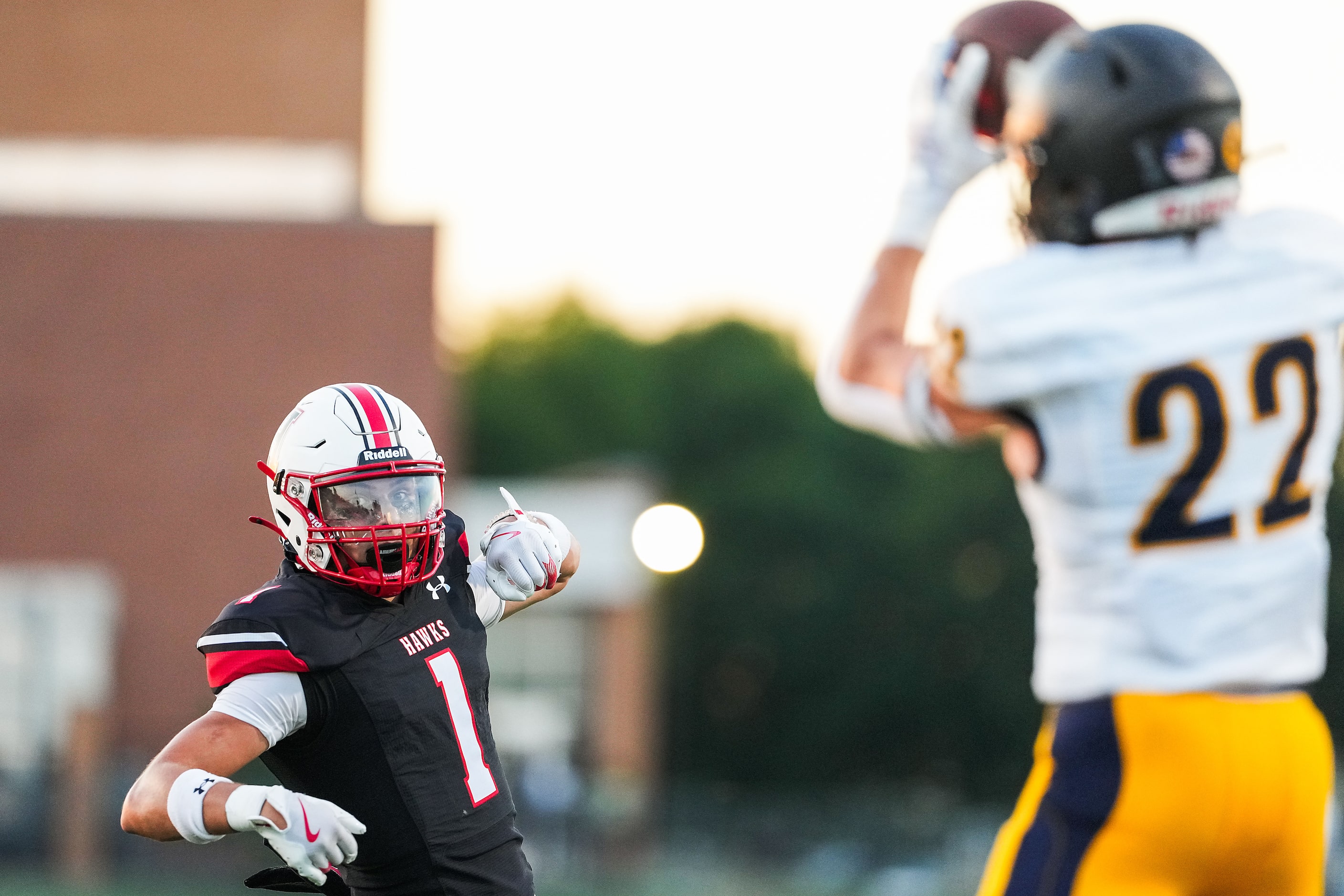 Rockwall-Heath wide receiver Jackson Traa (1) looks back to see Highland Park cornerback...