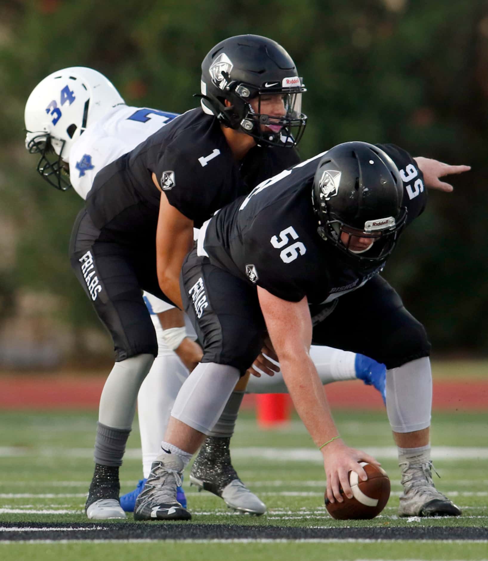 Bishop Lynch quarterback Michael Light (1) waits for the snap from center Liam Brace (56) as...