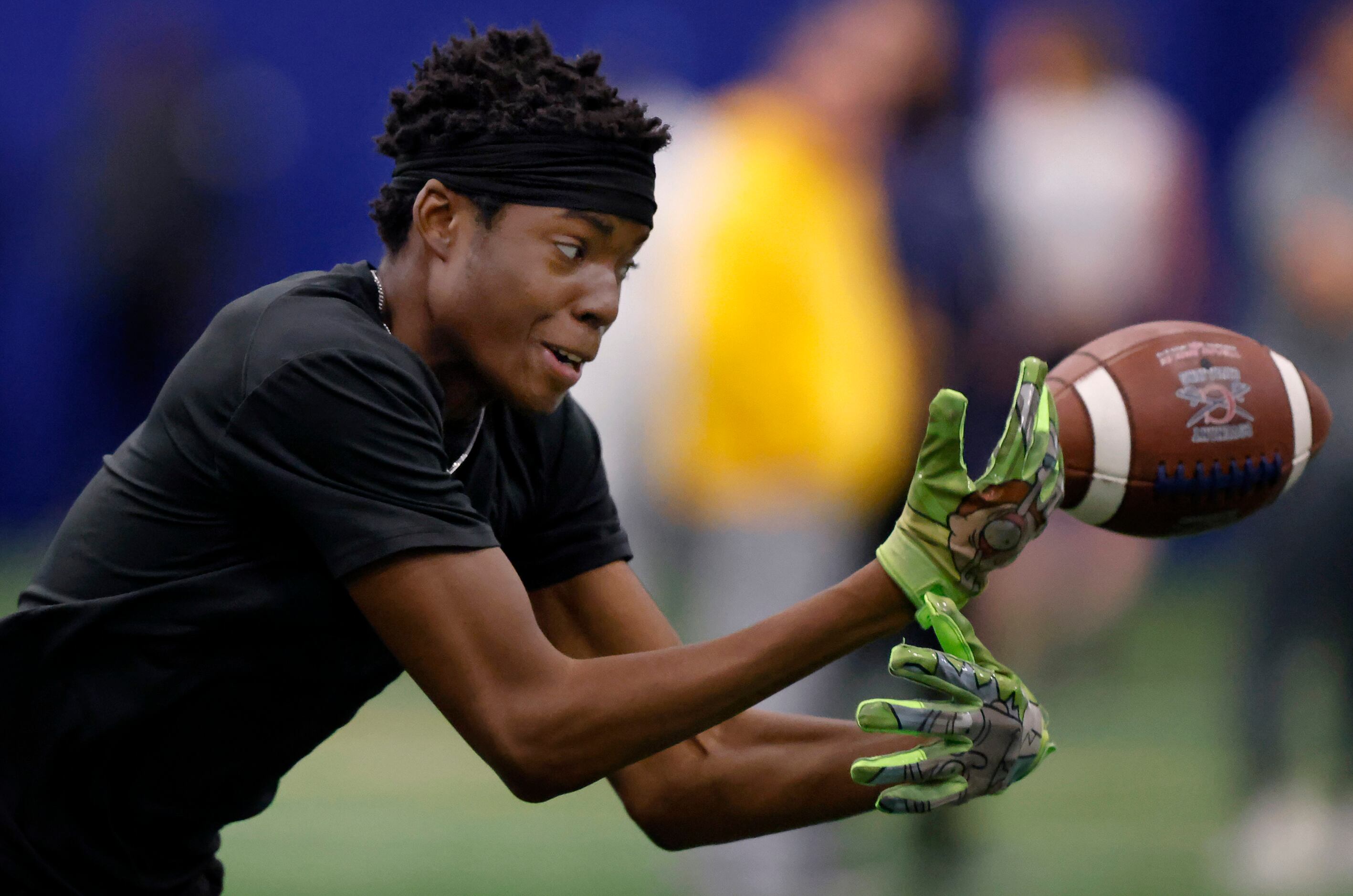 Unsigned senior wide receiver Zae Parker of Trinity High School stretches for a ball that...