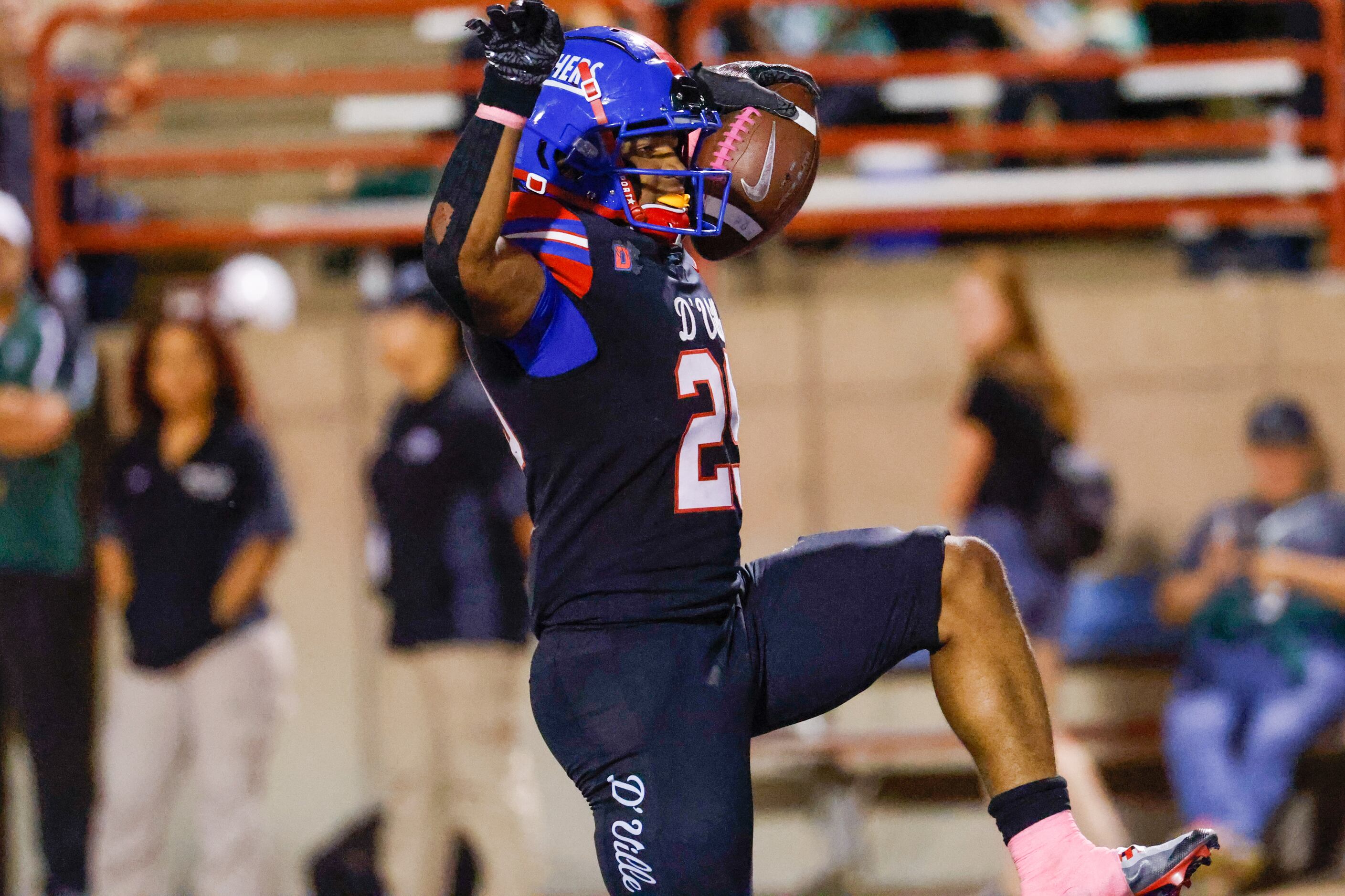 Duncanville running back Caden Durham (29) strikes a pose after carrying the ball into the...