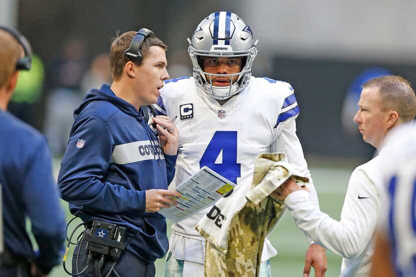 FILE - Dallas Cowboys quarterback Dak Prescott (4) listens to quarterback coach Kellen Moore...