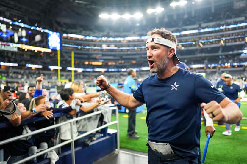 Dallas Cowboys offensive coordinator Brian Schottenheimer celebrates as he leaves the field...