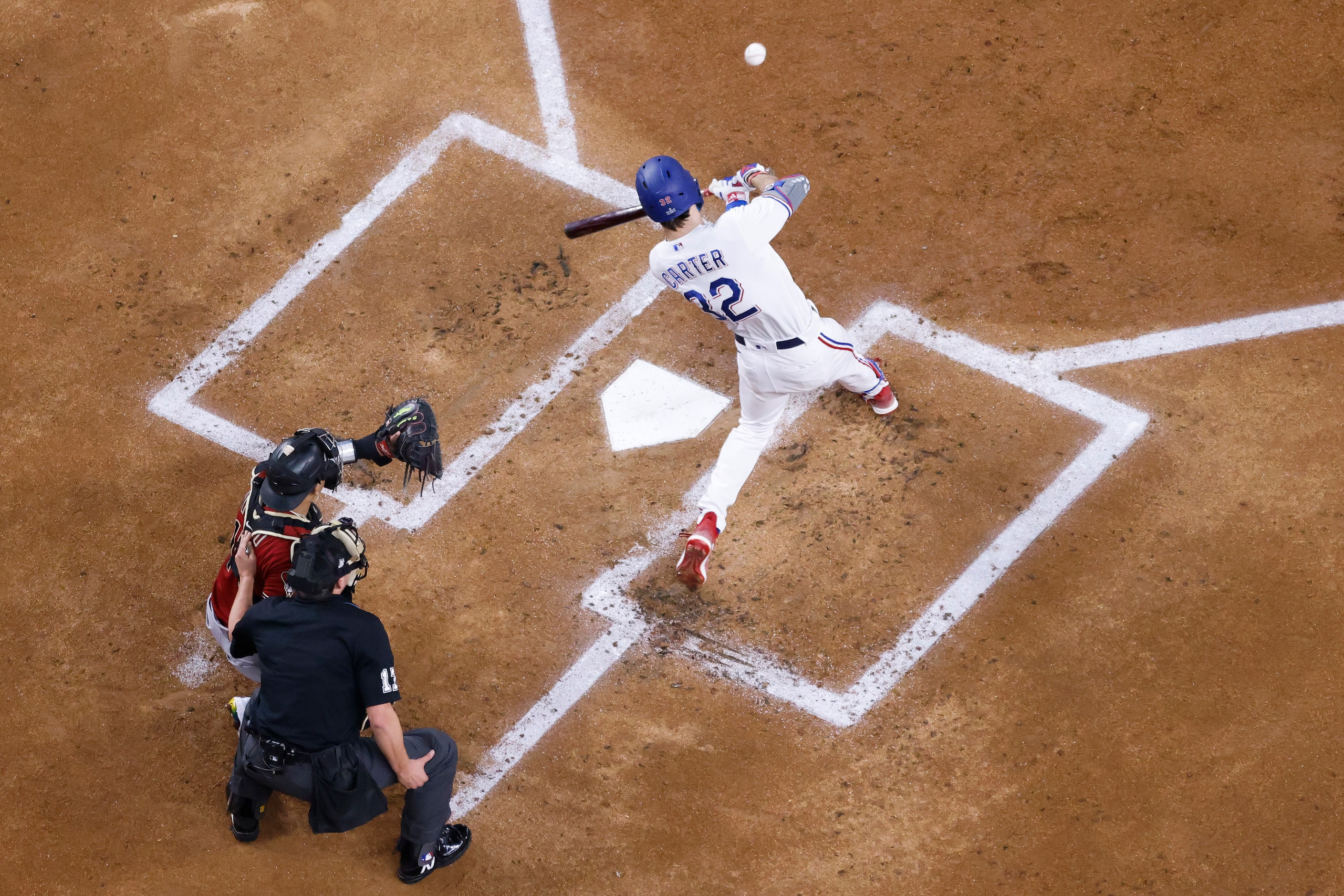 Texas Rangers' Texas Rangers left fielder Evan Carter (32) drives in Corey Seager with a...