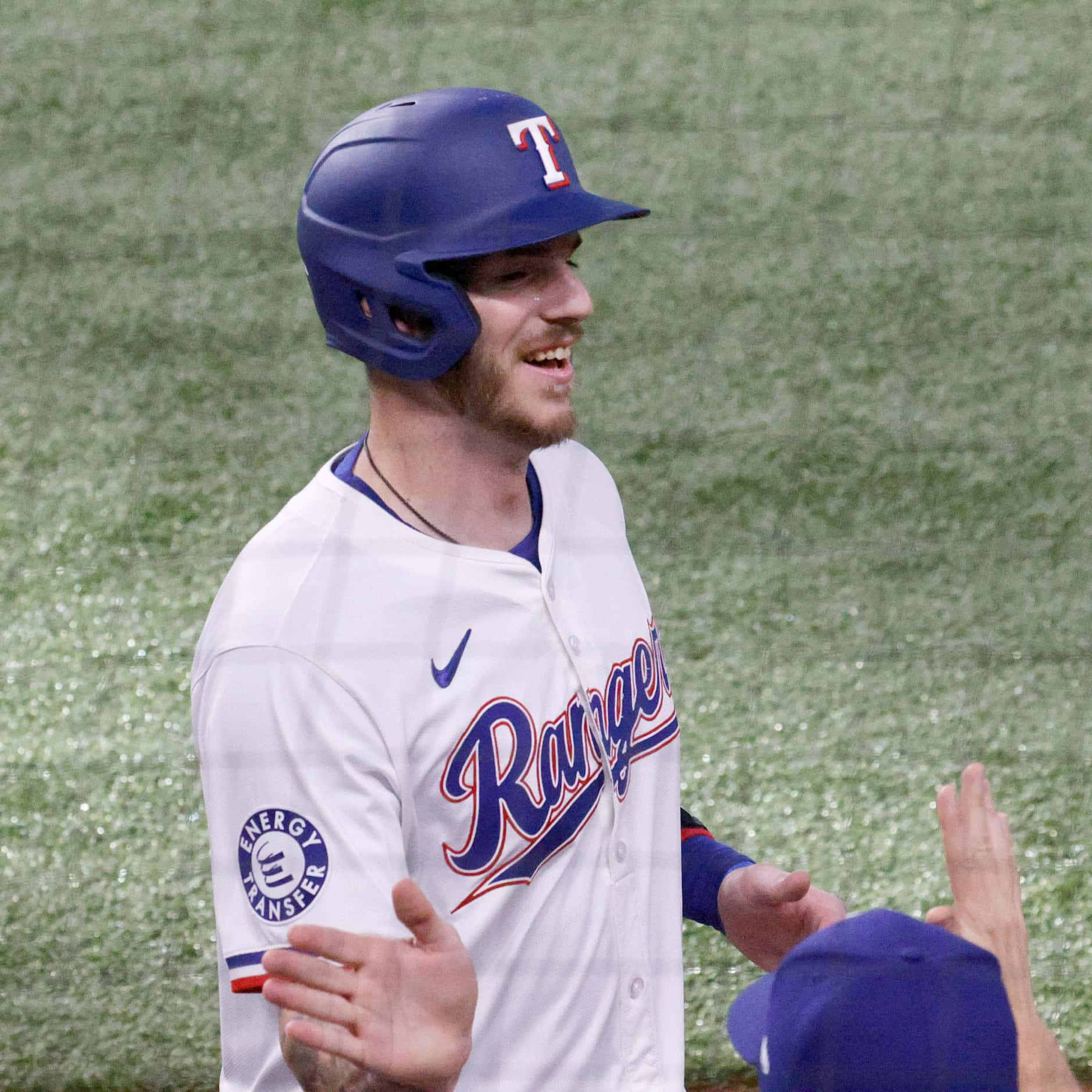 Texas Rangers catcher Jonah Heim (28) gets a high-five from his teammate after scoring on a...