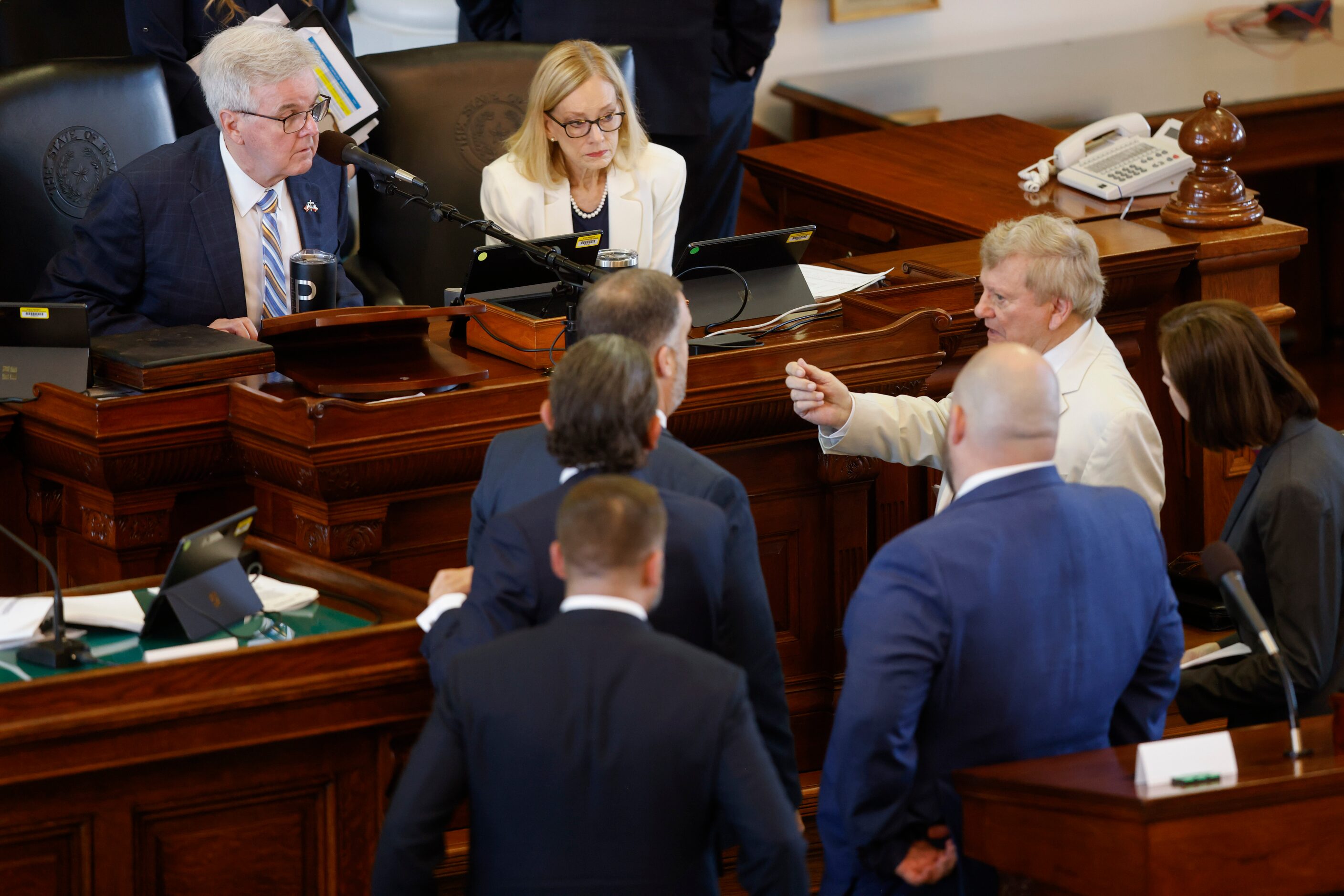 Lt. Gov. Dan Patrick (left) confers with defense and prosecution attorneys during a break on...