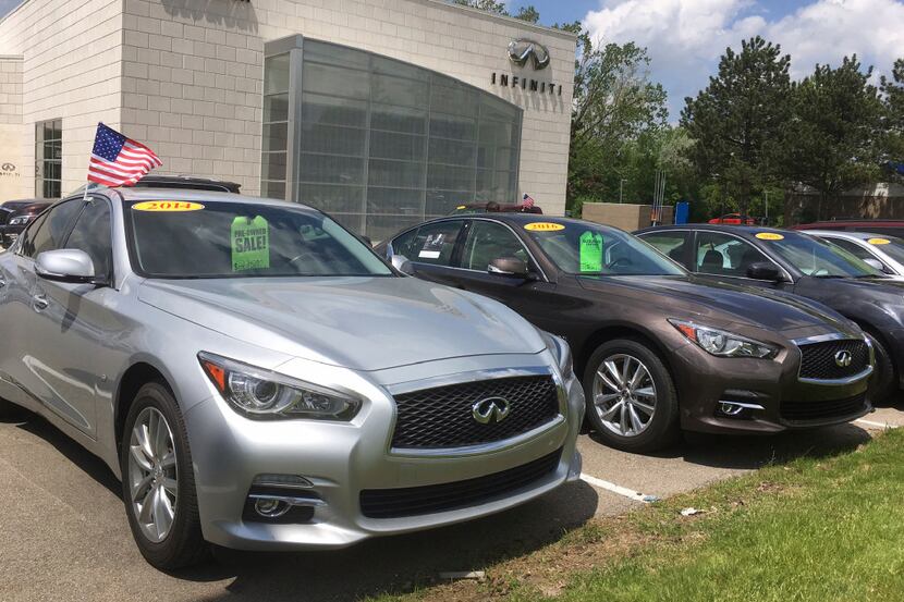 In this Wednesday, May 17, 2017, photo, used Infiniti Q50 luxury sedans await buyers at a...