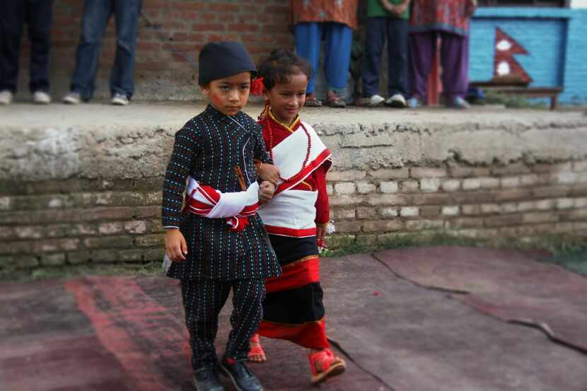 
Two children display their traditional Nepali clothing. 

