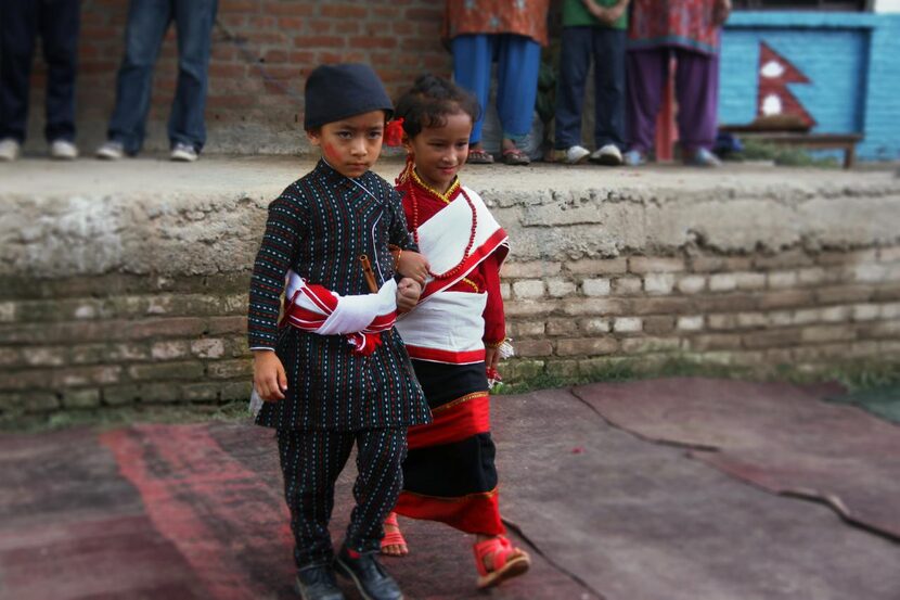 
Two children display their traditional Nepali clothing. 
