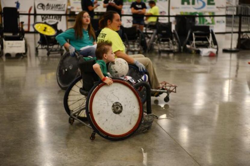 Bryce Winters, 8, plays quad rugby during the free skate at a two-day BMX and wheelchair...