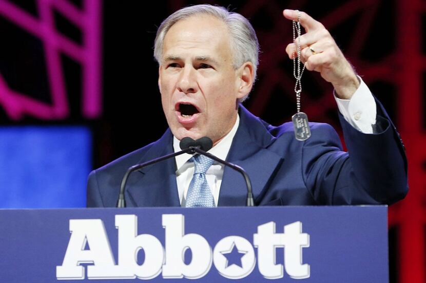  Gov. Greg Abbott held up a dogtag while speaking about the military service of his brother,...