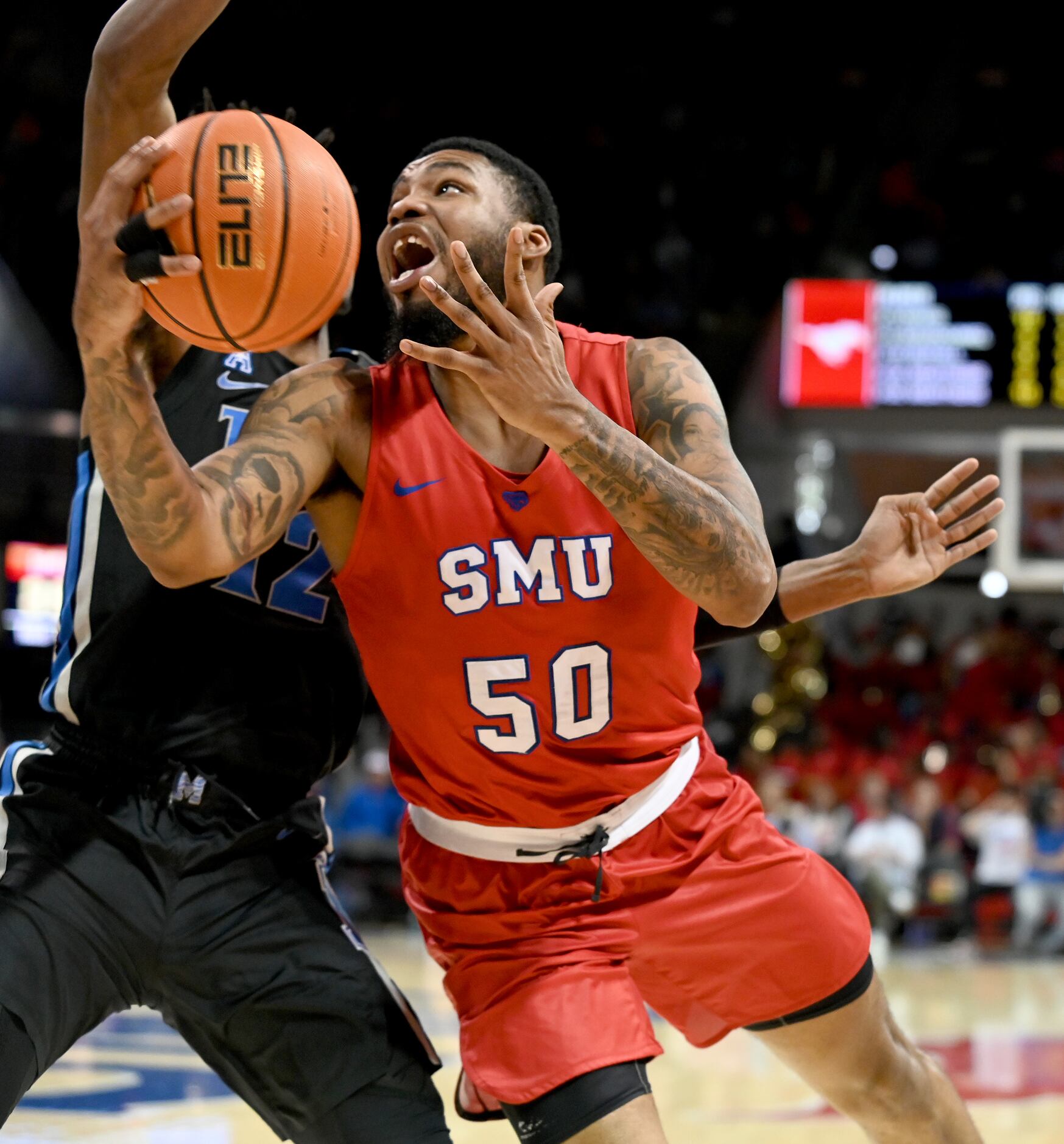 SMU forward Marcus Weathers (50) shoots on Memphis forward DeAndre Williams (12) in the...