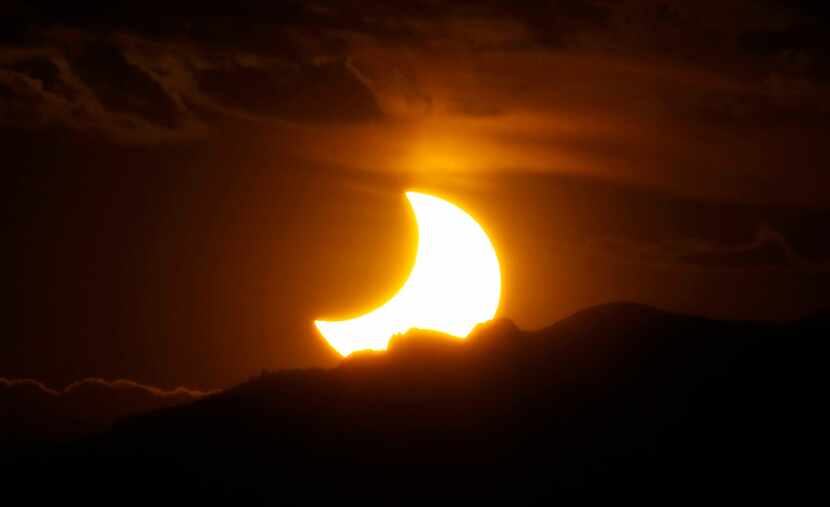 On May 20, 2012, a partial solar eclipse was seen from downtown Denver as the sun set behind...