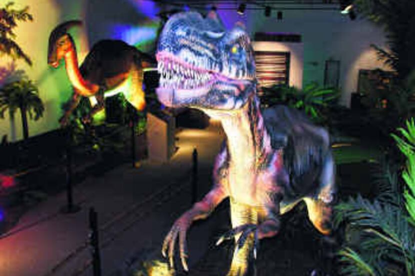  The exhibit includes 14 animatronic dinosaurs that roar and move in their junglelike setting. 