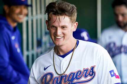 Texas Rangers catcher Sam Huff celebrates after scoring during the ninth inning of a spring...