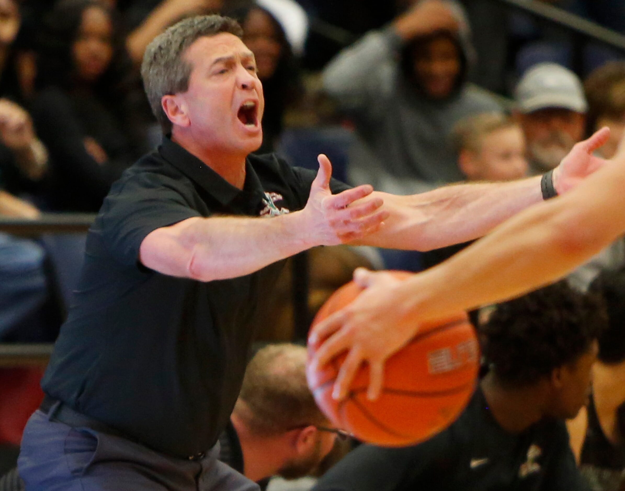 Waxahachie head coach Greg Gober passionately delivers game strategy and encouragement to...