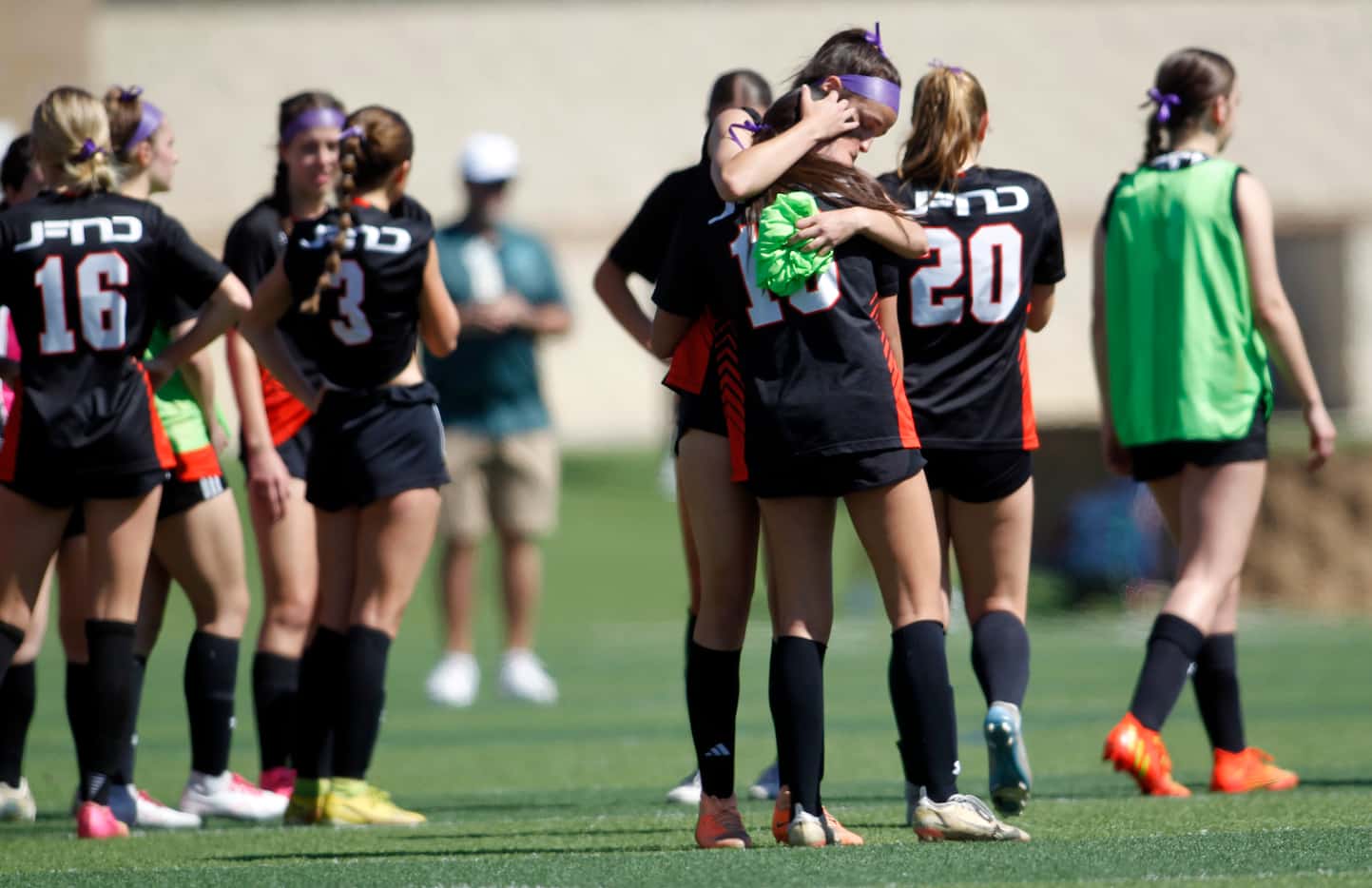  Rockwall midfielder Kai Spencer (11), (3rd from right) gives a consoling hug to teammate...
