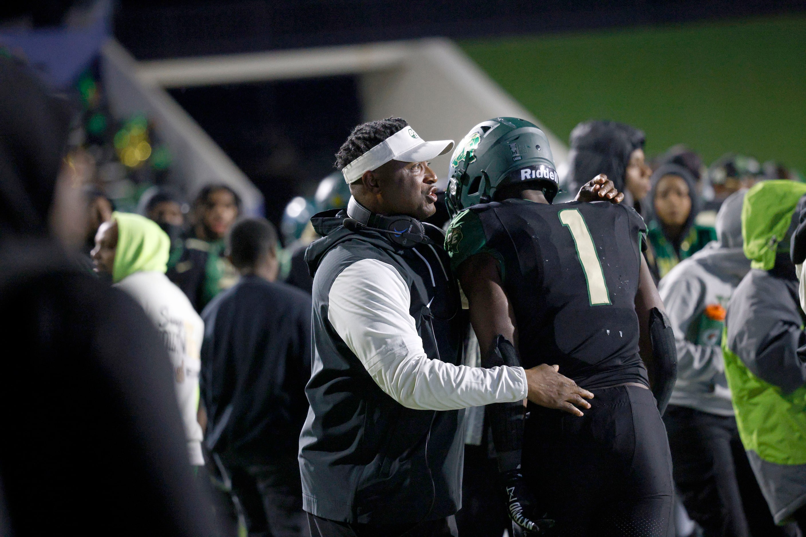 DeSoto's Deondrae Riden Jr. (1) celebrates with DeSoto's head coach Claude Mathis after...