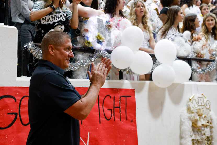 Martin High School head football coach Bob Wager claps during a cheer performance at a...