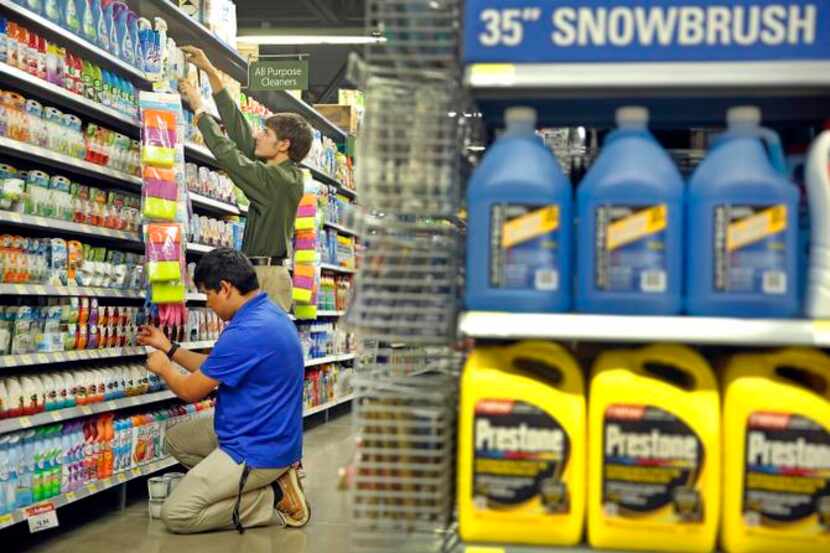 
Jonathan Amador (front) and Zackery Middleton fine-tune the household goods section as they...