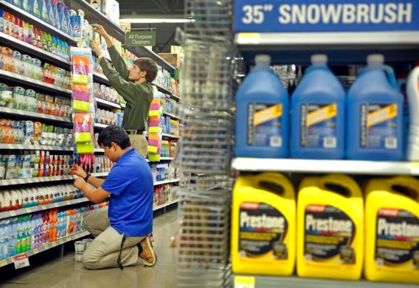 
Jonathan Amador (front) and Zackery Middleton fine-tune the household goods section as they...