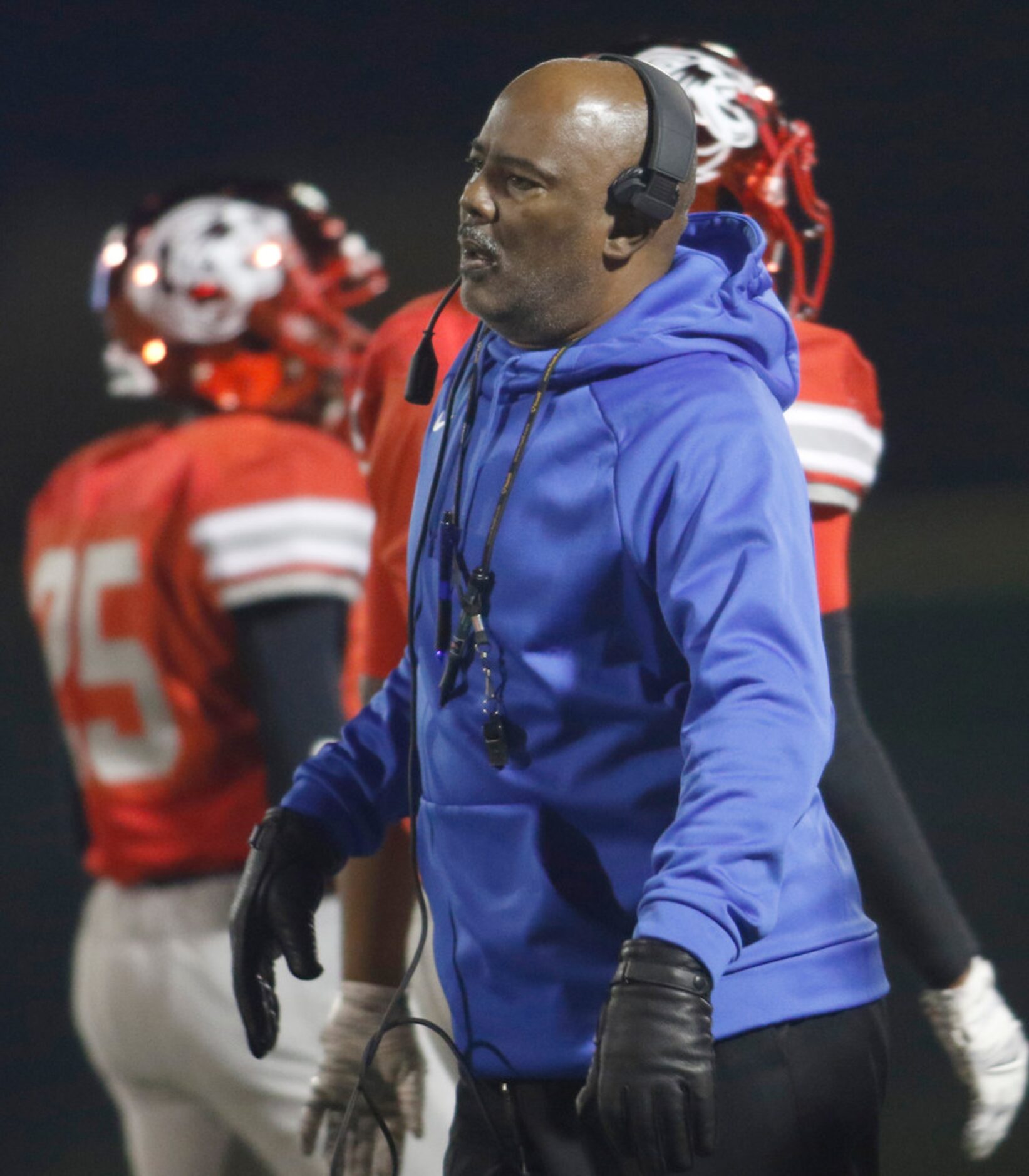 Duncanville Panthers head coach Reginald Samples directs his players from the team sidelines...