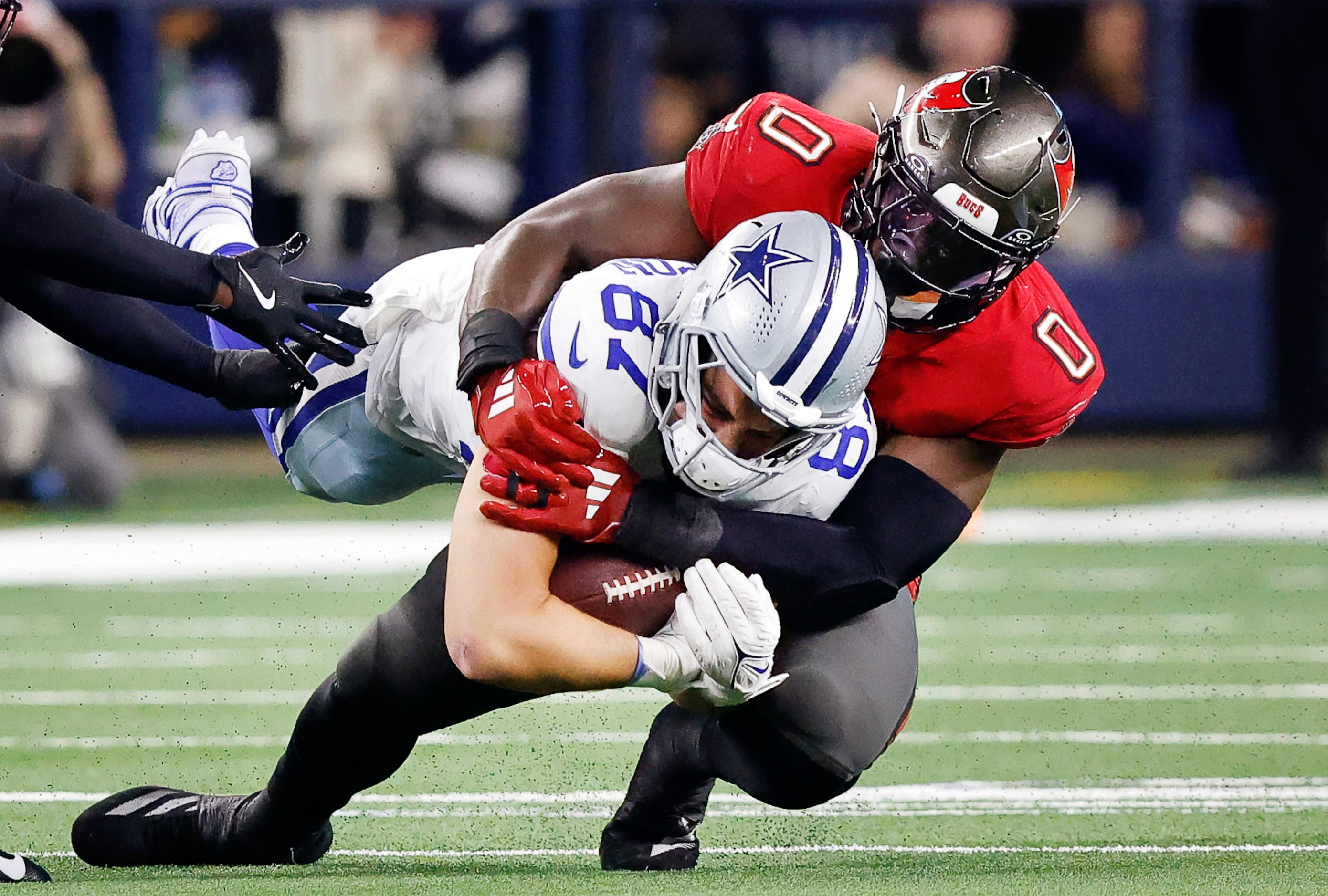 Dallas Cowboys tight end Jake Ferguson (87) is wrestled to the turf by Tampa Bay Buccaneers...