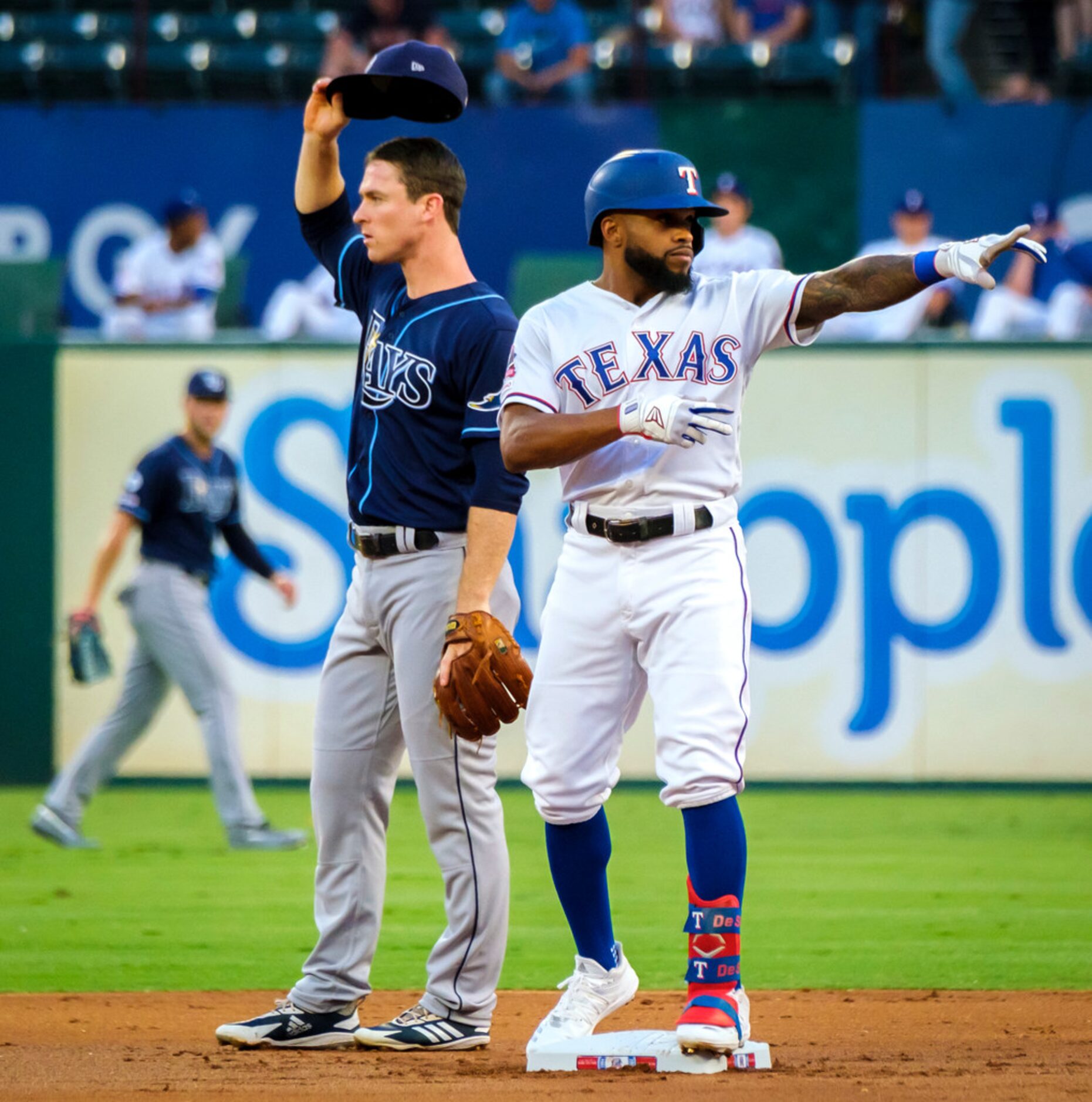 Texas Rangers outfielder Delino DeShields celebrates at second base after hitting a leadoff...