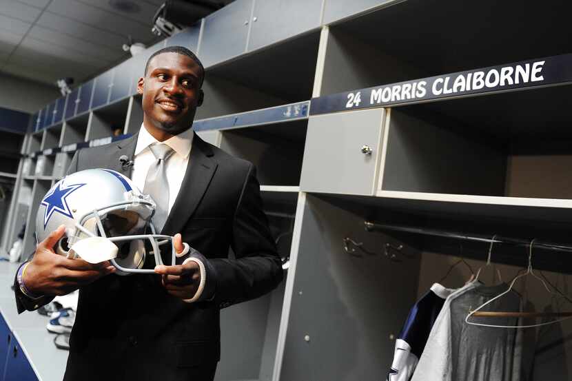 Dallas Cowboys first-round draft choice Morris Claiborne holds a helmet near his locker at...