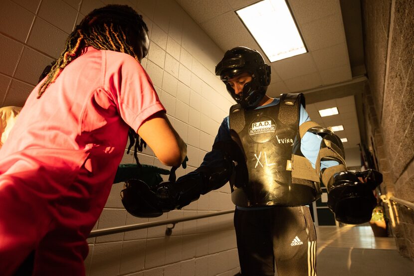 Anjali Reitmeyer, 16, right, fits into a training suit with help from Terri Miles, left,...