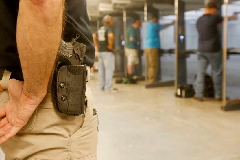 Shooting instructor Mark Brushwiller wears his gun on his hip at the Frisco Gun Club.