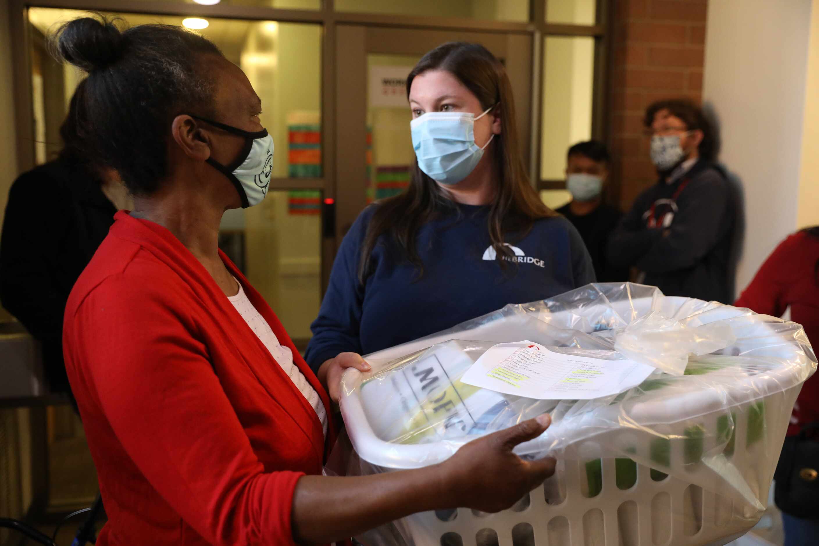Intensive care manager Amanda Espinosa (right) gifts Patricia Freeman with a basic of...