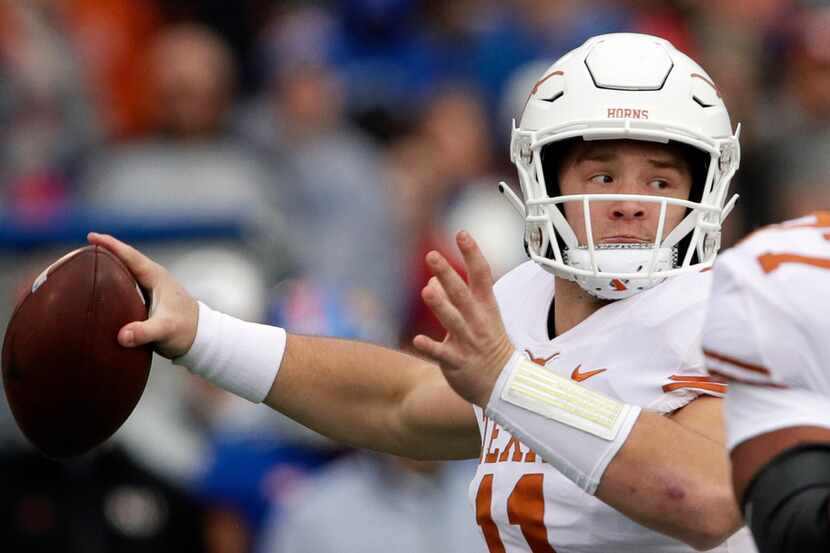 Texas quarterback Sam Ehlinger (11) passes to a teammate during the first half of an NCAA...