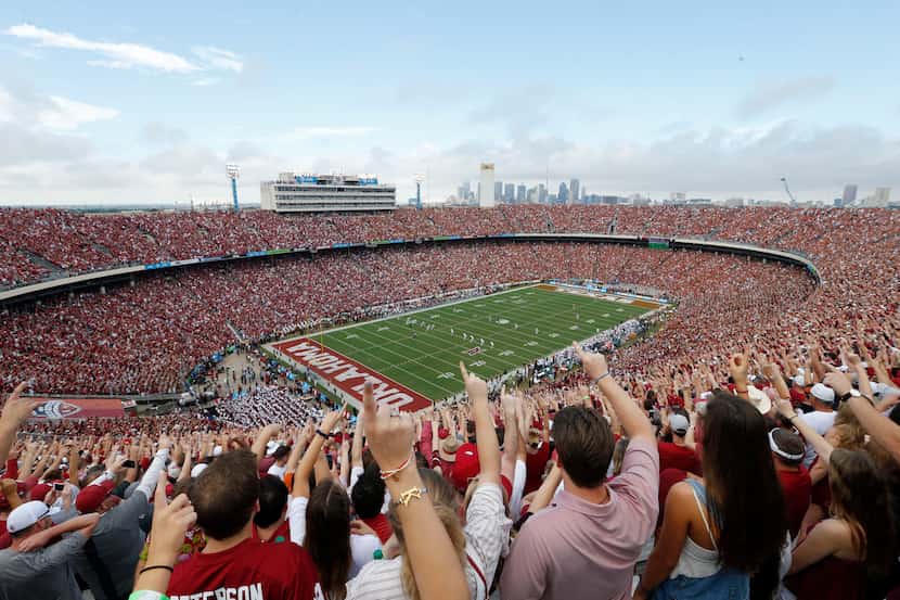 Oklahoma Sooners fans yell as Texas Longhorns kick the ball off to Oklahoma at the start of...