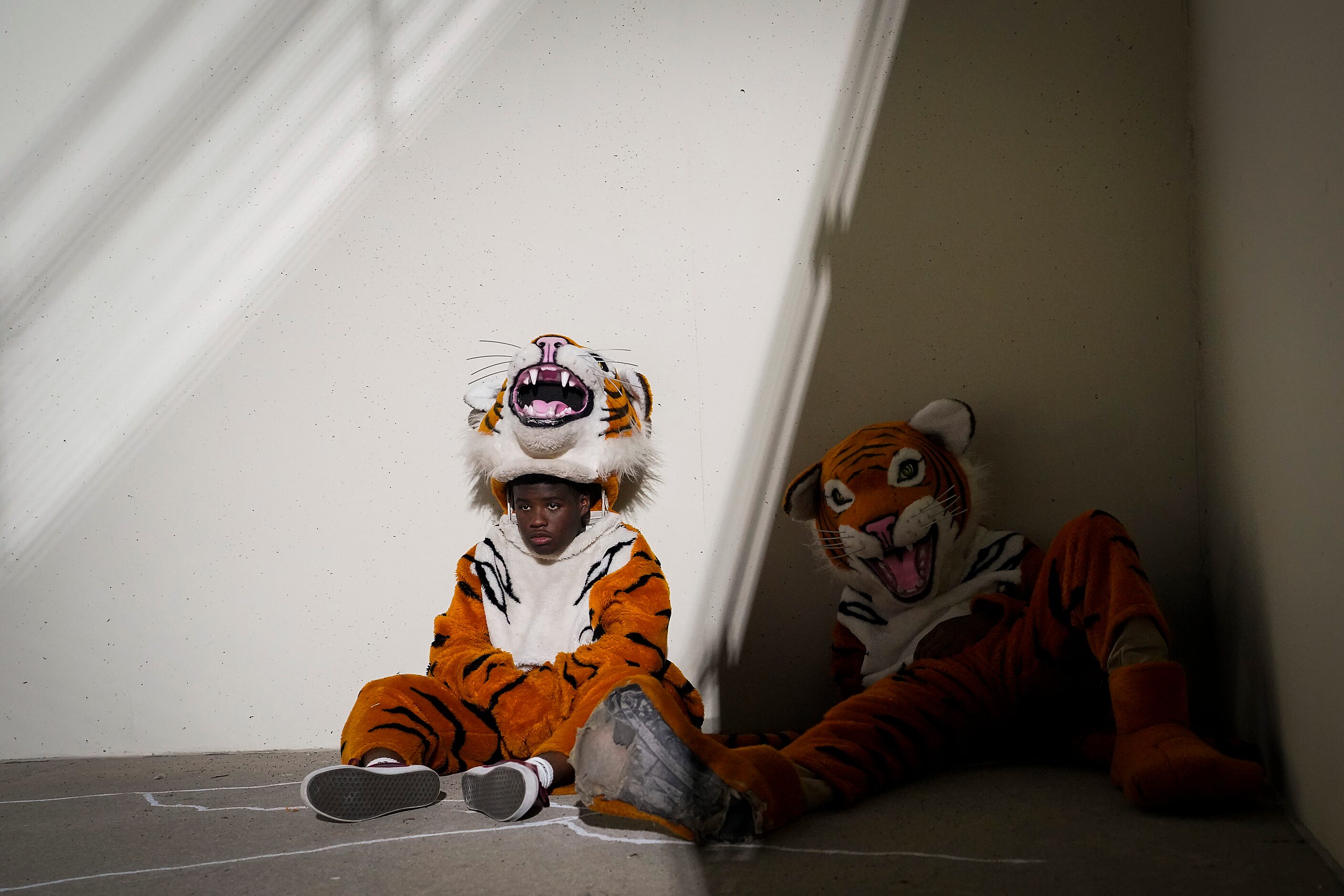 Lancaster mascots relax on the sidelines during halftime of a high school football game...