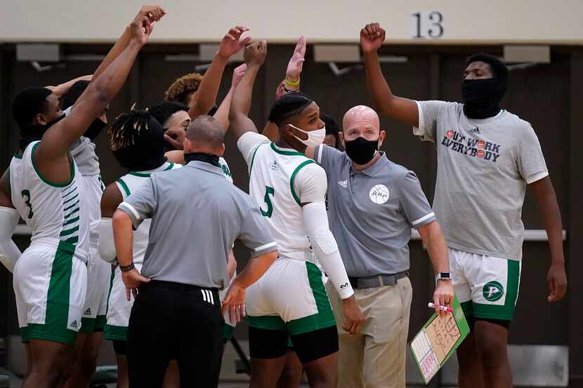 Mesquite Poteet players, including guard Jaran Young (5), guard Derrick Martin (3) and...