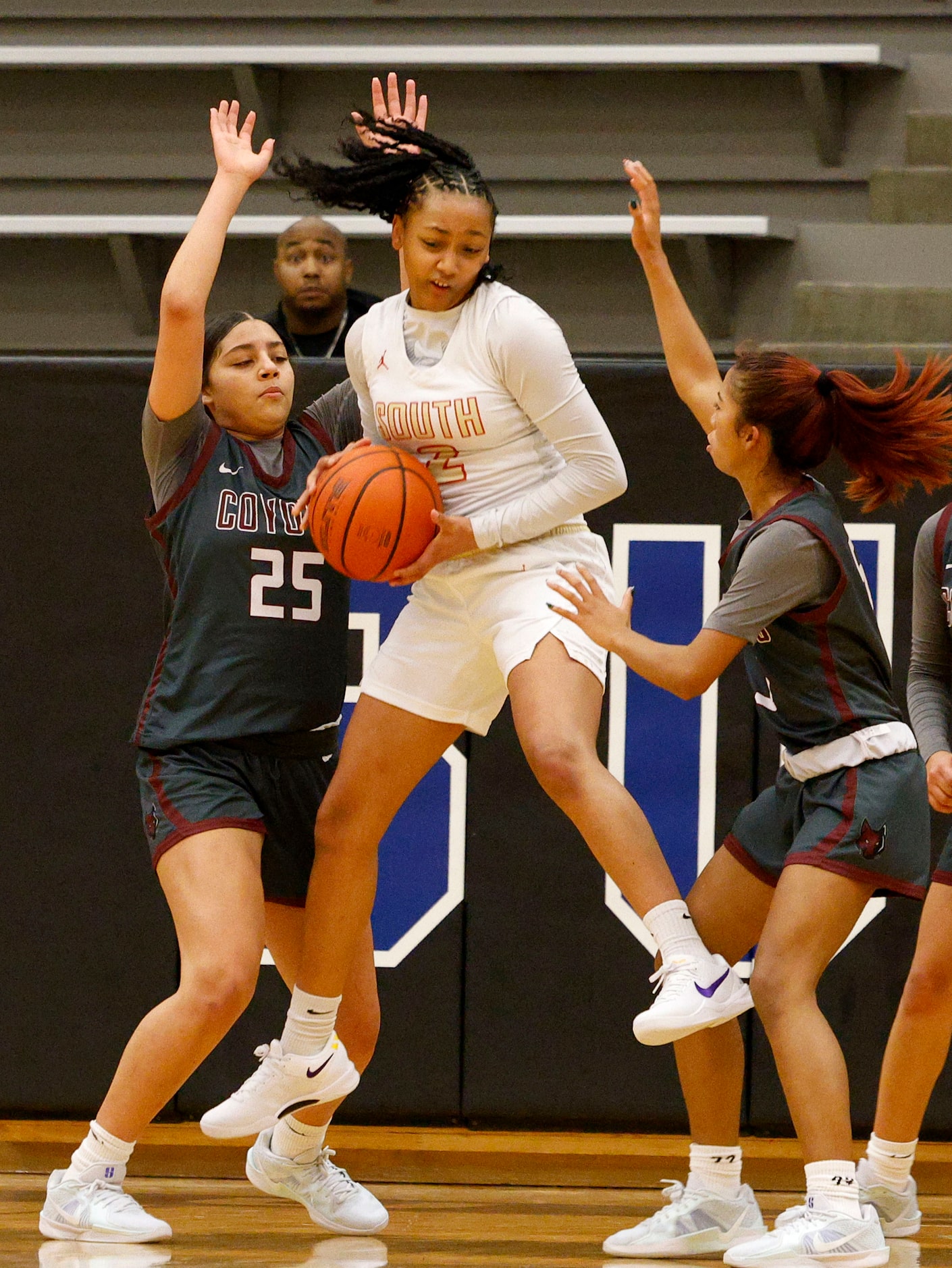 South Grand Prairie's Payton Garrett (2) gets a rebound as Frisco Heritage's Ella Hooper...