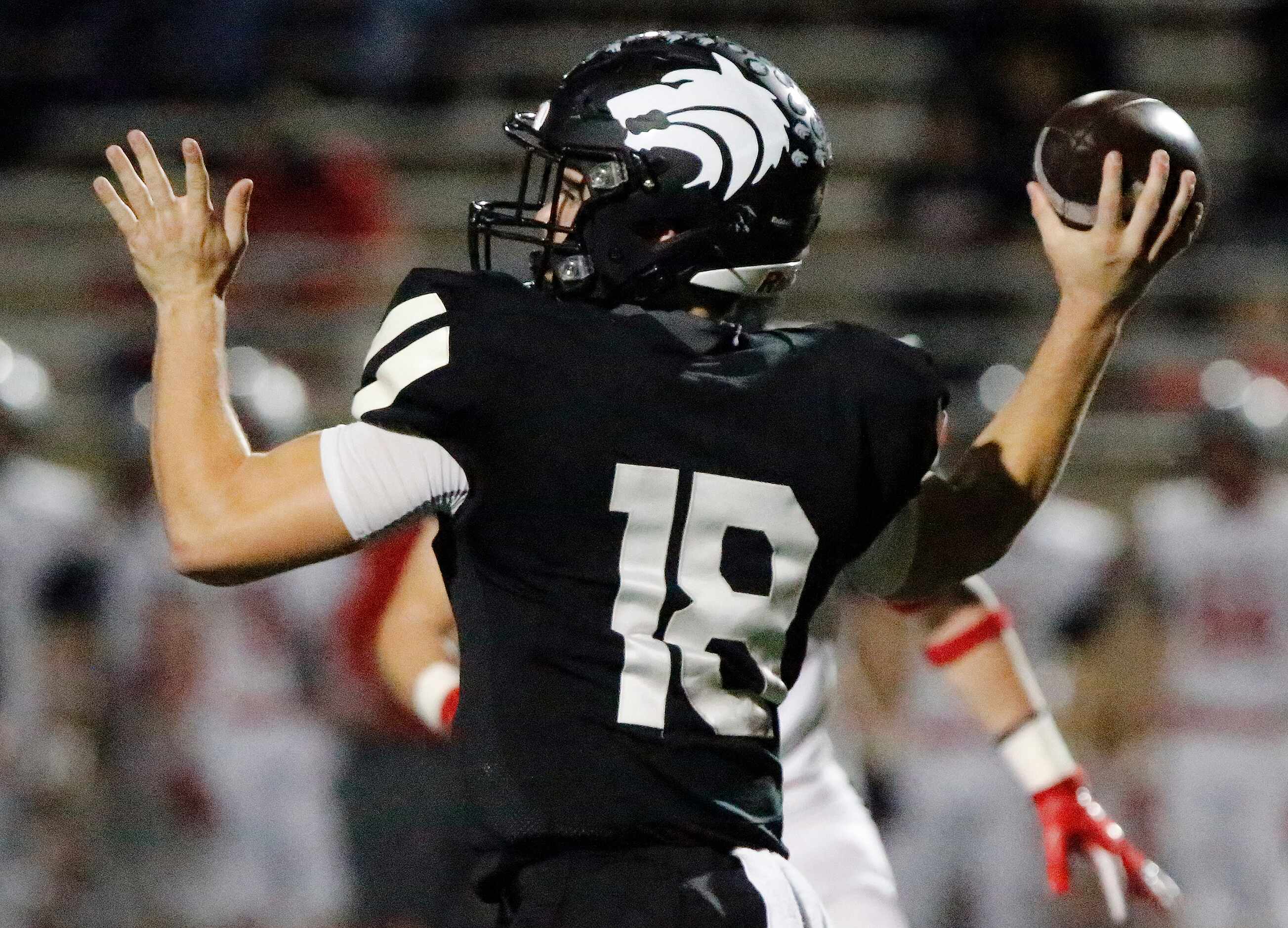 Plano West High School quarterback Greg Draughn (18) throws a pass during the first half as...