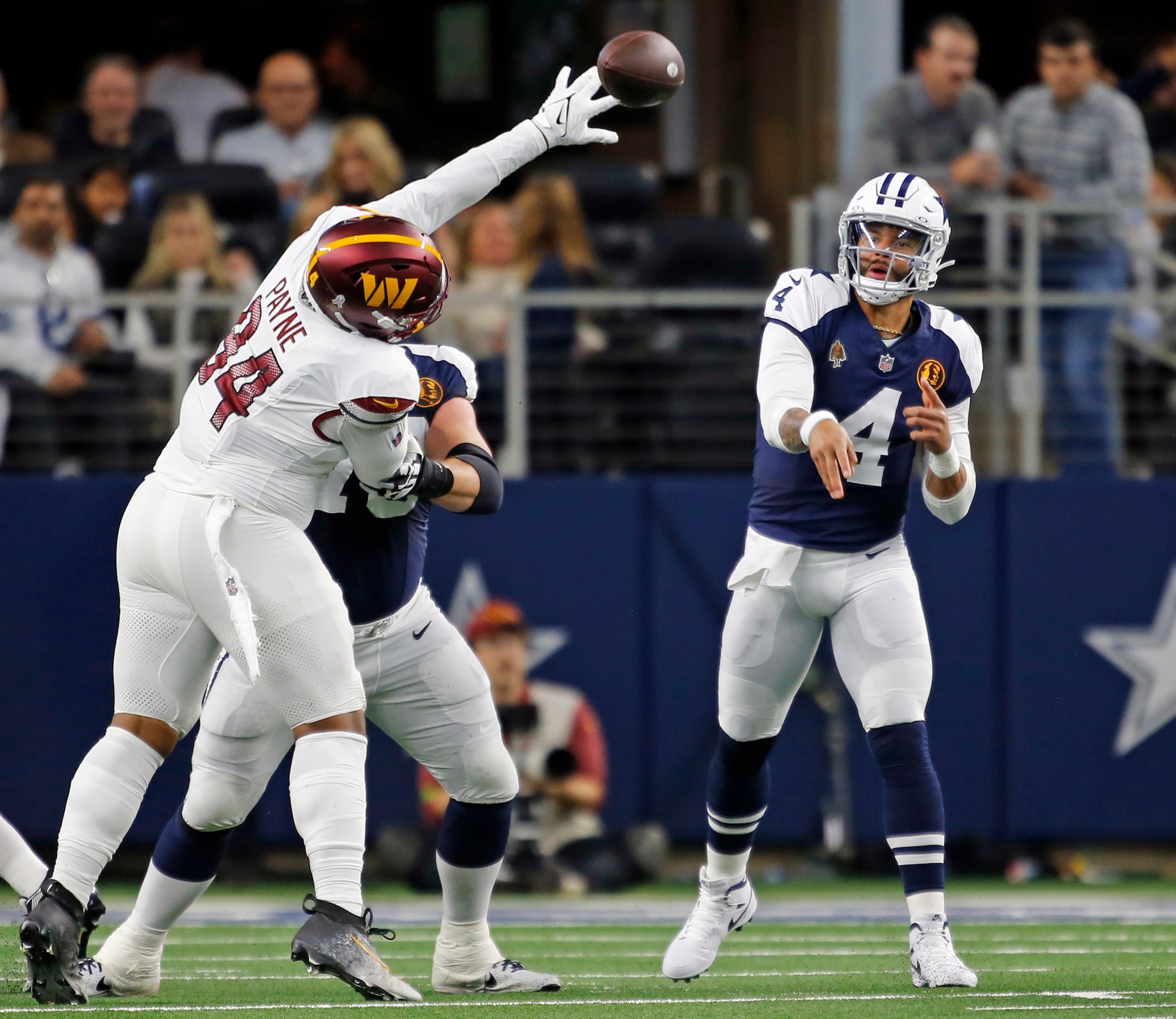 Dallas Cowboys quarterback Dak Prescott (4) throws a pass, as a Washington defender tries to...