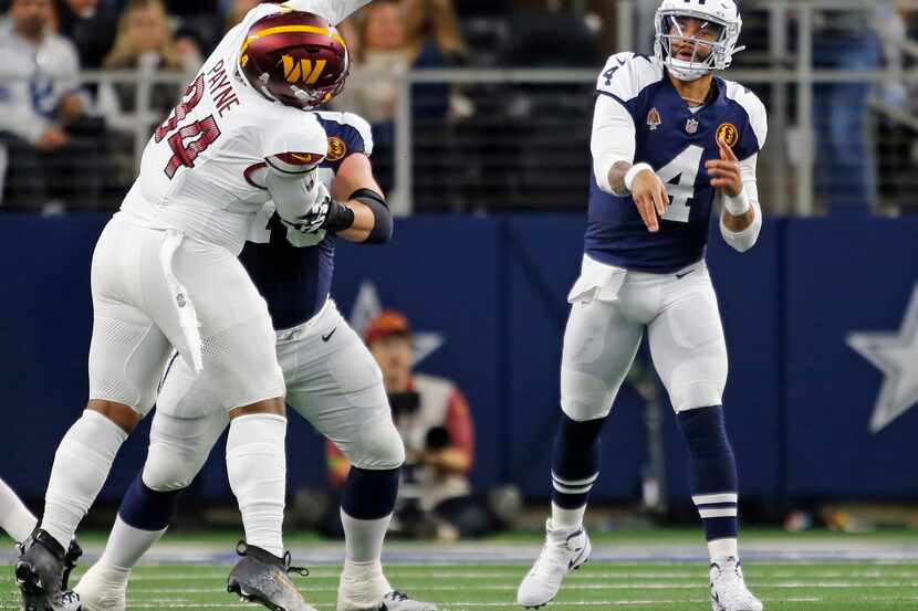 Dallas Cowboys quarterback Dak Prescott (4) throws a pass, as a Washington defender tries to...