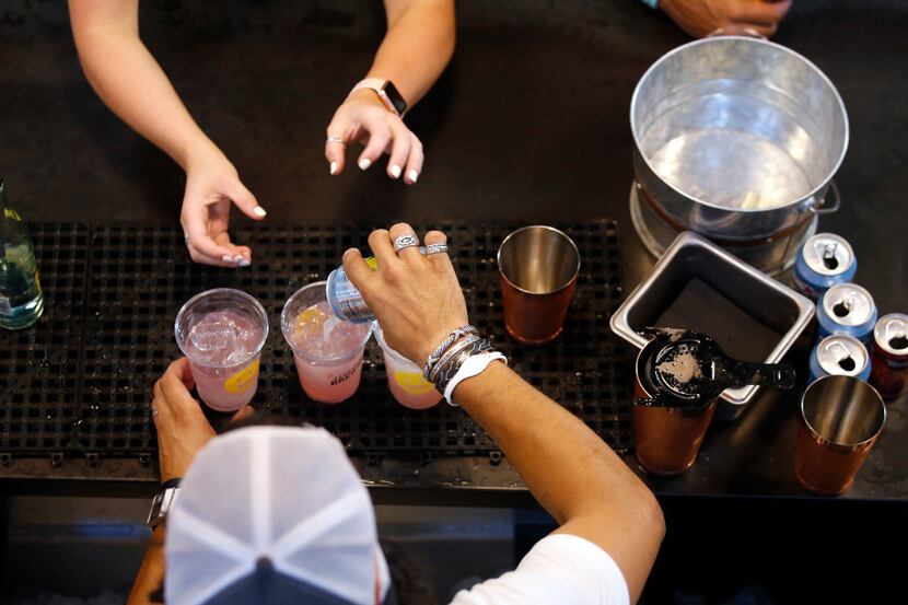 Tony Martinez makes drinks for guest during the Deep Ellum Distillery launch party for its...