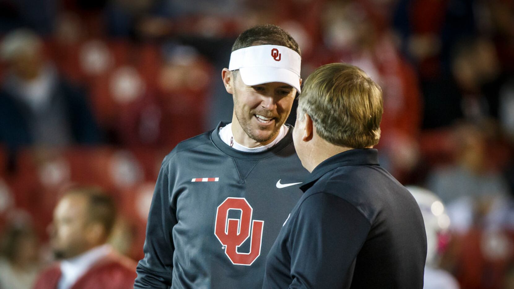 Oklahoma head coach Lincoln Riley chats with TCU head coach Gary Patterson before an NCAA...