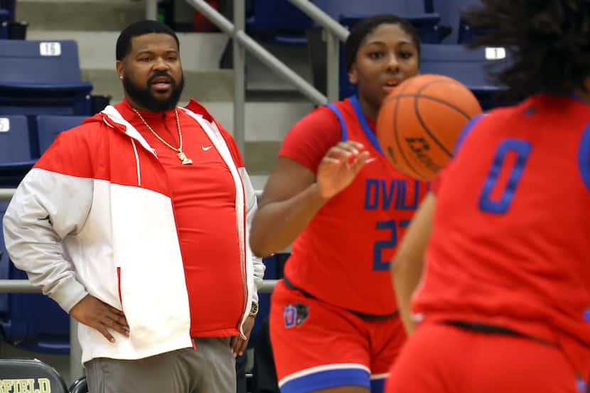 Duncanville Pantherettes head coach Neiman Ford, left, intently watches his players during...