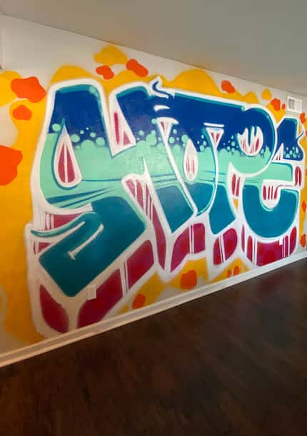 A mural inside the Dallas Hope Center's current property reads "Hope" in large, colorful...
