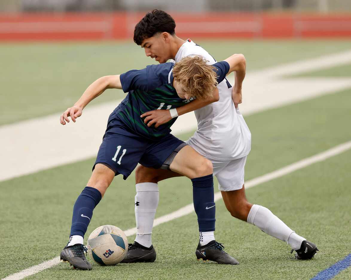 Frisco Reedy’s Carson Schoenbeck (11) and McKinney North’s Marcus Casarez (12) battle for...