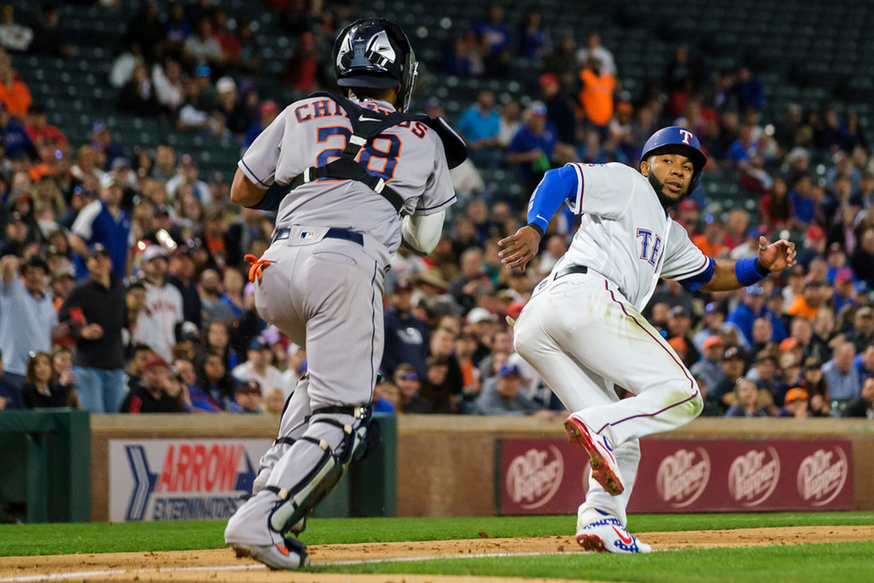 Texas Rangers shortstop Elvis Andrus is caught in a rundown trying to score on a groundout...