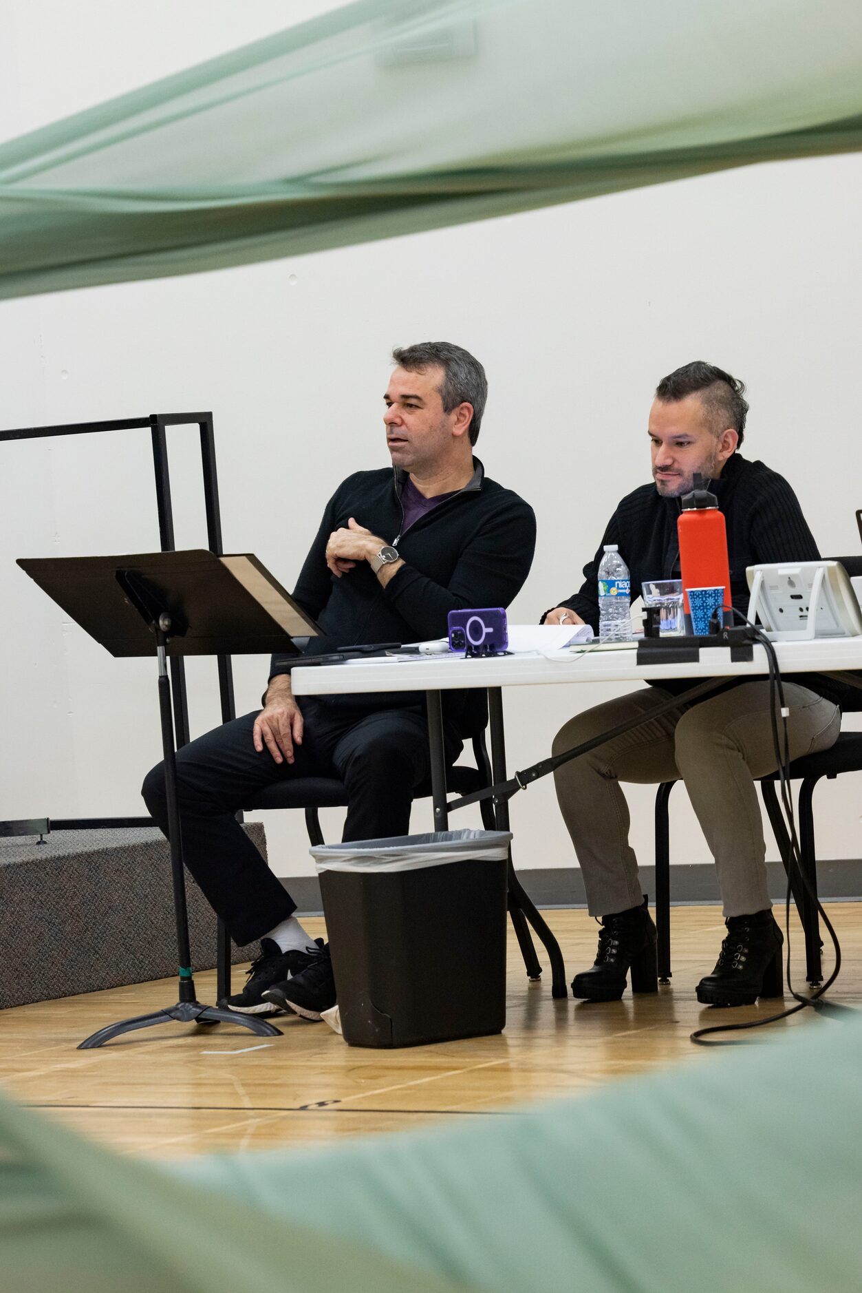 Director Tomer Zvulun (left) and assistant director Gregory Boyle watch as singers perform...