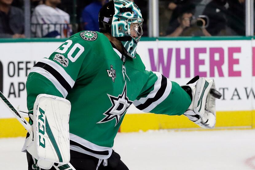 Dallas Stars goalie Ben Bishop (30) reaches out to glove a shot from the New York Islanders...