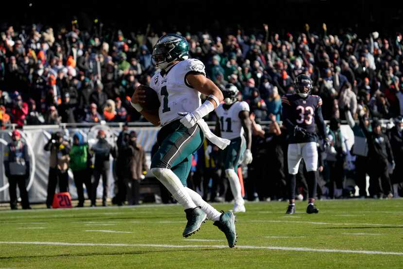 Philadelphia Eagles' Jalen Hurts runs for a touchdown during the first half of an NFL...