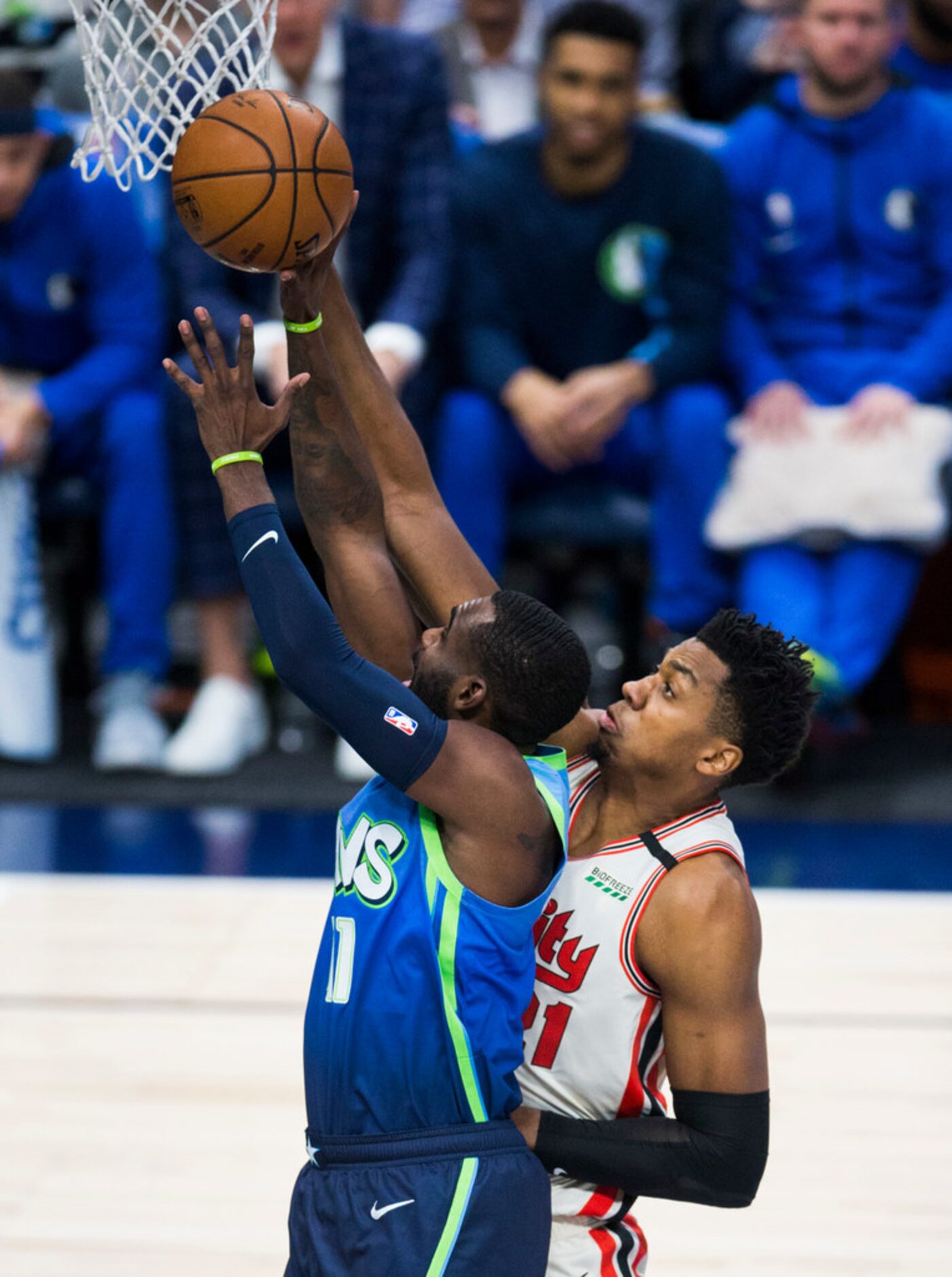 Dallas Mavericks guard Tim Hardaway Jr. (11) goes up for a shot defended by Portland Trail...