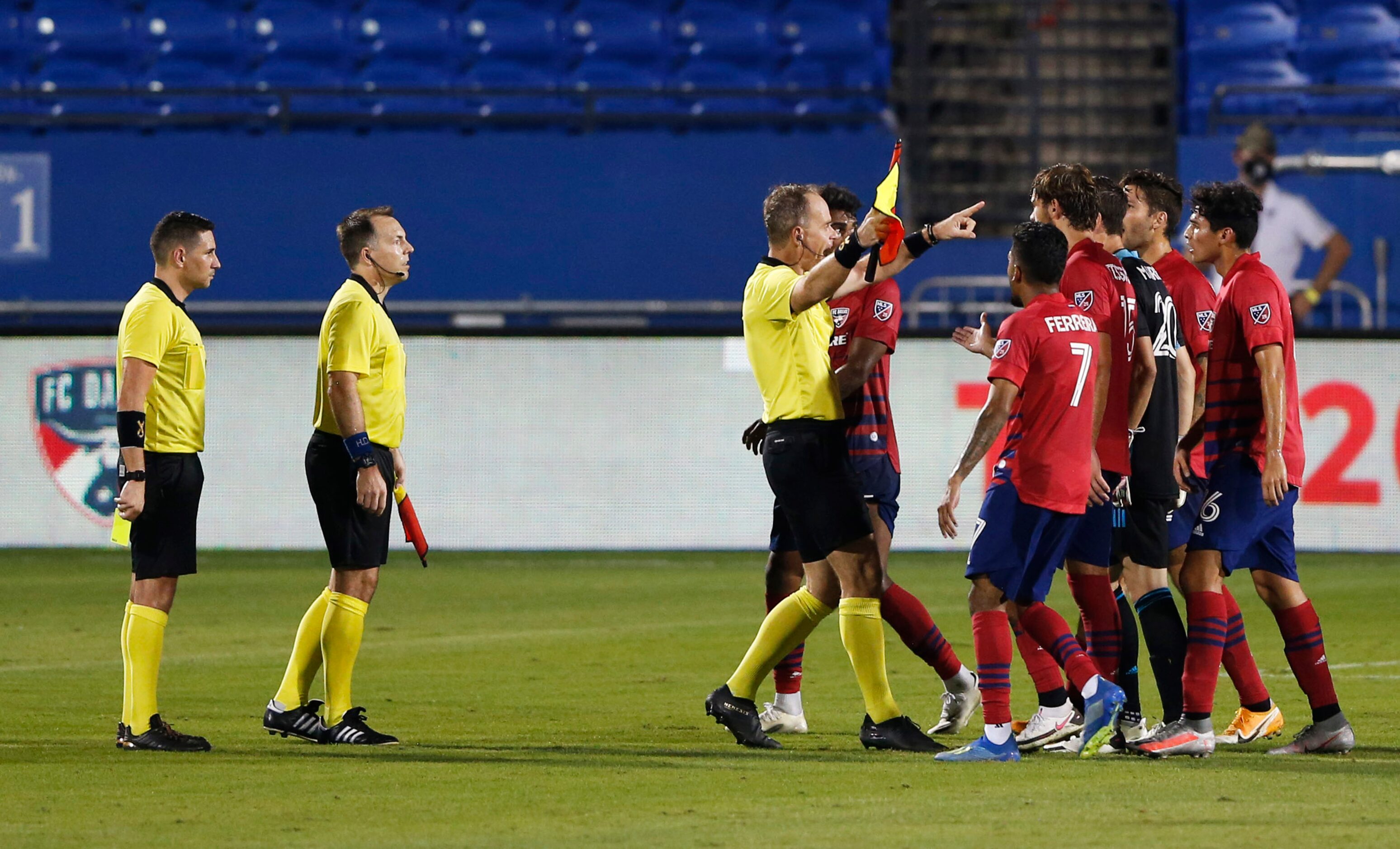 FC Dallas players argue the calling of the end of the game with referees after the end of...